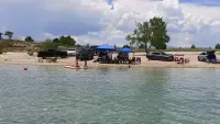 Beach setup with canopies and kayaks